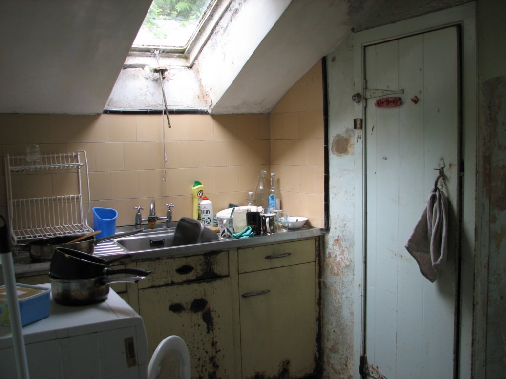 There's no sink in the kitchen itself but instead in a narrow room just behind the kitchen we call the scullery. There's also a rather lovely (but totally ineffectual in summer) pantry with thick slate shelves. It's not the prettiest area of the house these days, but it is functional